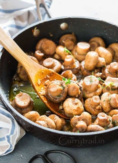 cooking sauteed mushroom recipe with butter garlic and thyme in skillet