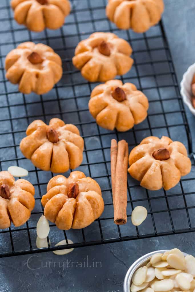 pumpkin cookies shaped like pumpkin shape on wire rack