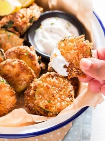 serving baked zucchini chips with creamy sauce