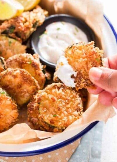 serving baked zucchini chips with creamy sauce