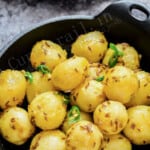 aloo jeera in bowl with text