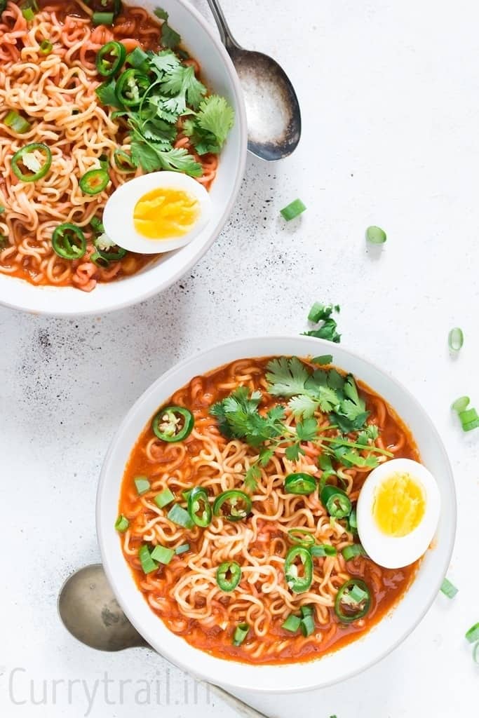 two white bowls with sriracha ramen noodles soup 