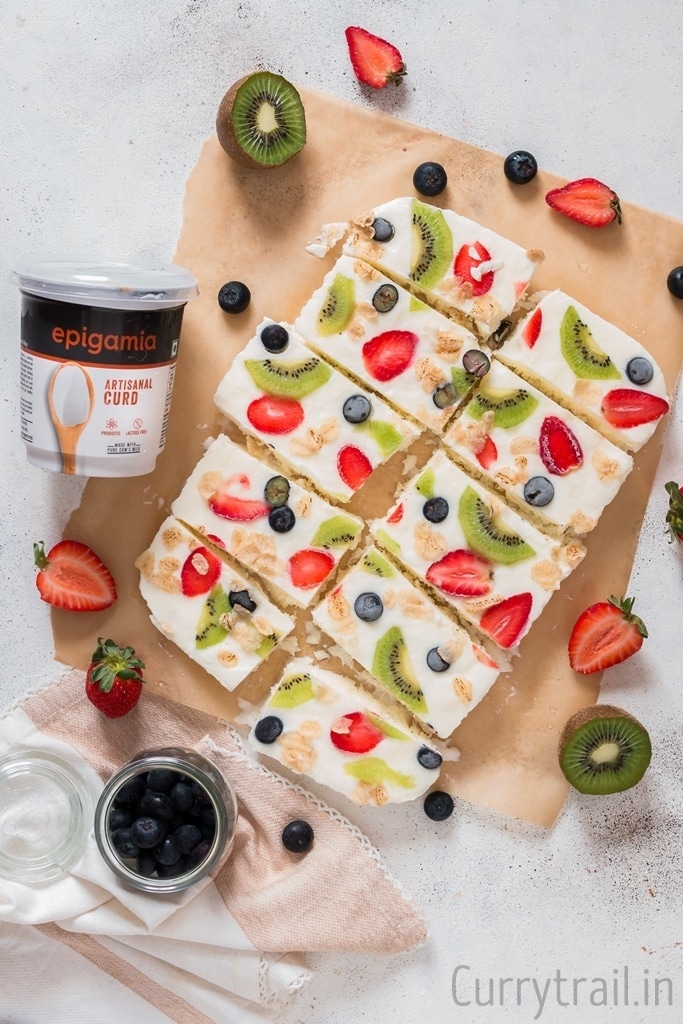 Sliced frozen yogurt bark on parchment paper