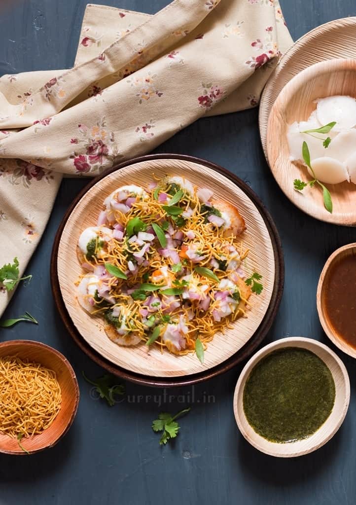Idli chaat on a plate with chutney's on the side