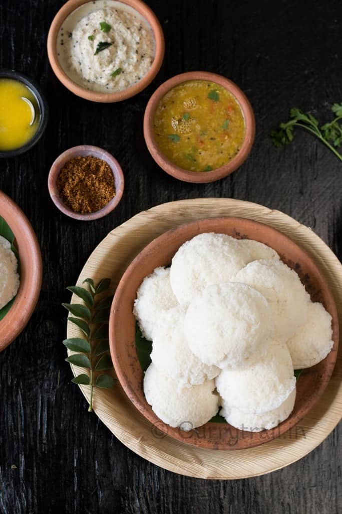 Soft fluffy Idli with chutney, sambar and ghee on sides
