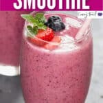 mixed berry smoothie in two tall glasses with text
