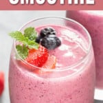 a glass full of mixed berry smoothie with text