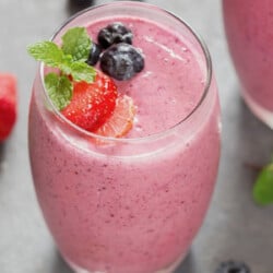 close up view of berry smoothie in a glass.