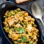 Ridge gourd cooked with scrambled eggs in cast iron bowl and bread slices