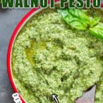 basil pesto with walnuts in small bowl with text