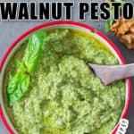 fresh basil walnut pesto in bowl with wooden spoon with text overlay