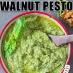 fresh basil walnut pesto in bowl with wooden spoon with text overlay