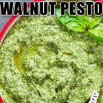 fresh basil walnut pesto in bowl with wooden spoon with text overlay