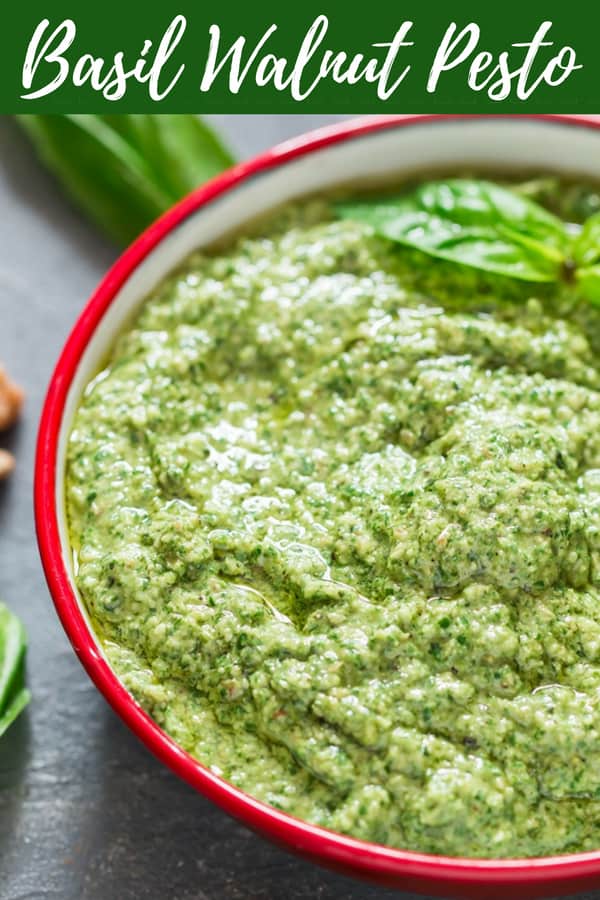 healthy vegan basil walnut pesto in white bowl with text overlay