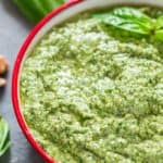 Basil Walnut Pesto in a bowl with wooden spoon