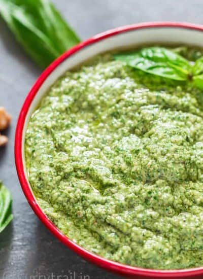 Basil Walnut Pesto in a bowl with wooden spoon