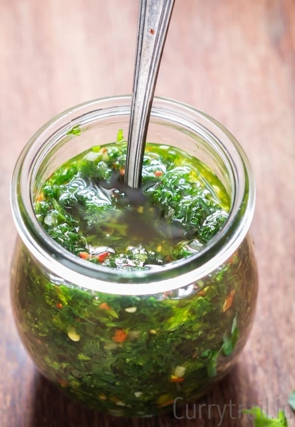 spicy sauce made of fresh herbs in a jar with spoon