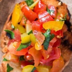 Rainbow colored fresh tomato bruschetta with fresh basil leaf