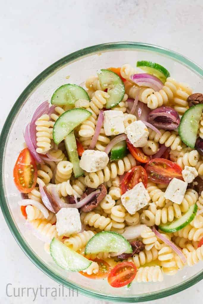 Greek pasta salad in glass salad bowl