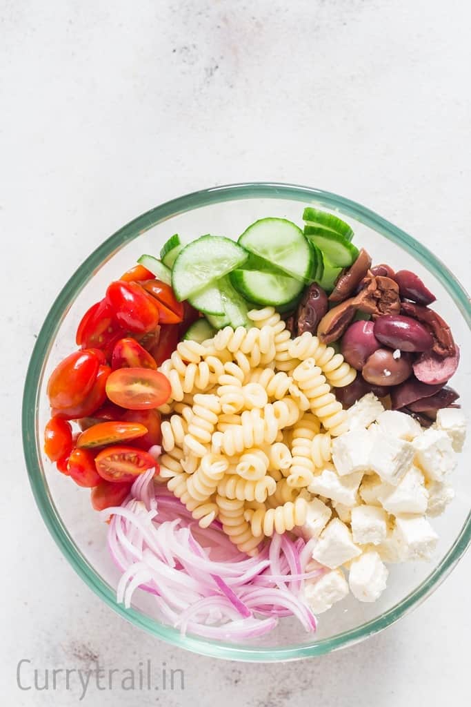 Ingredients for Greek pasta salad in a bowl