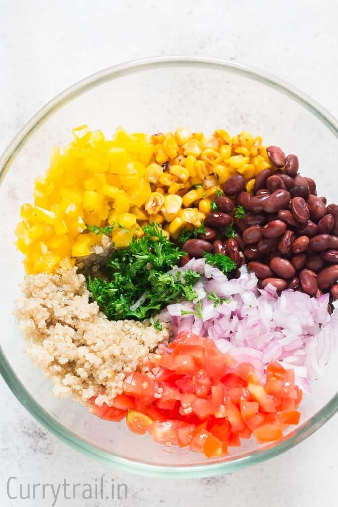 Ingredients for Mexican quinoa salad bowl in a glass bowl