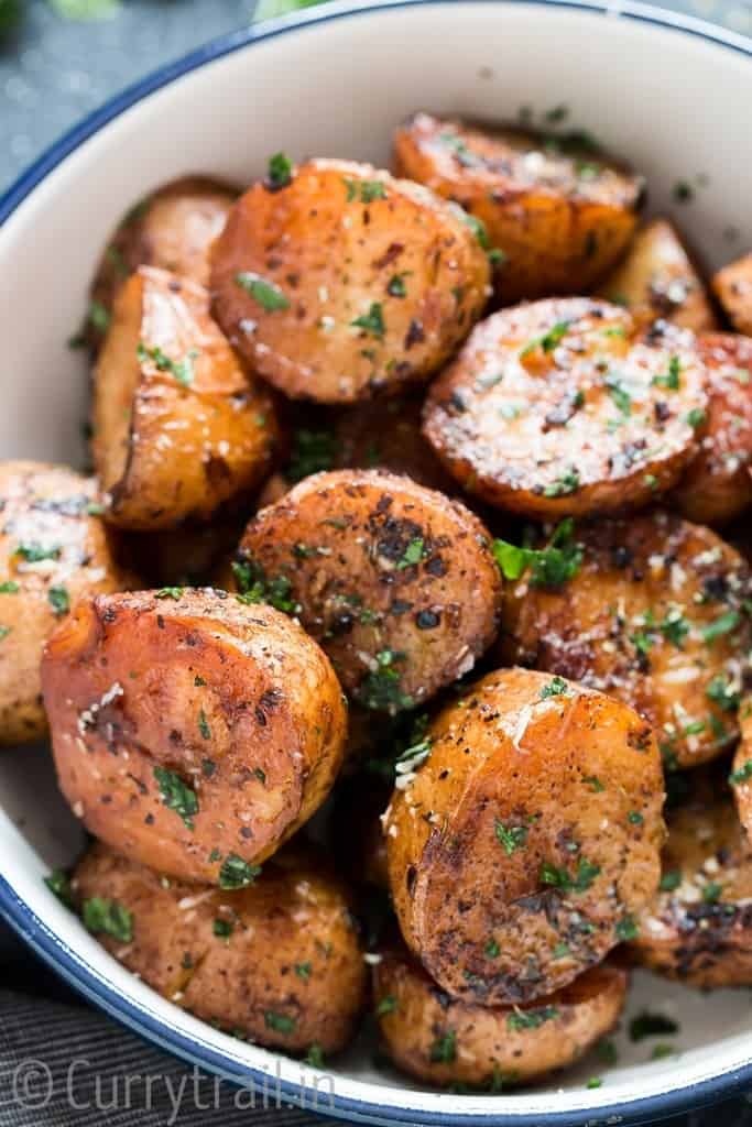instant pot potatoes roasted with garlic butter and herbs served in white bowl