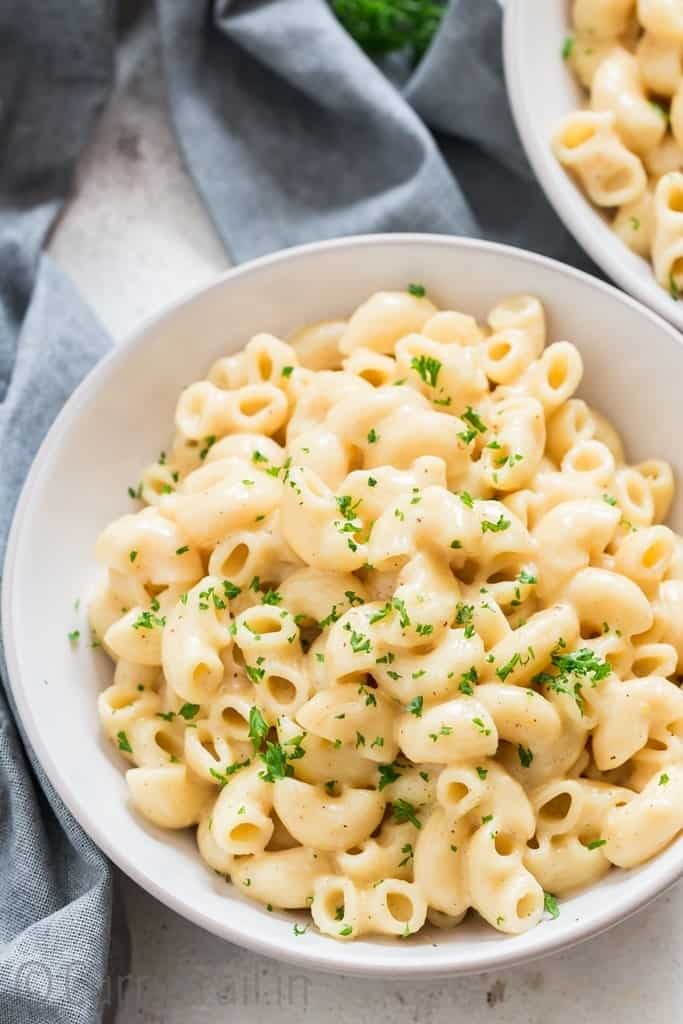 close up view of bowl of instant pot macaroni and cheese with parsley