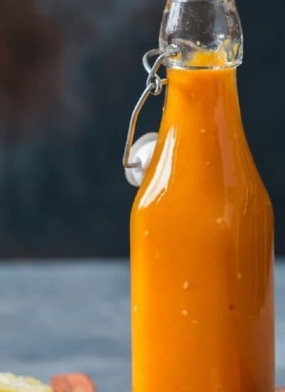 hot sauce made of mango and habanero in a glass jar.