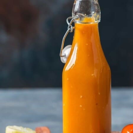 hot sauce made of mango and habanero in a glass jar.