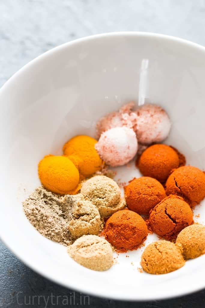 Spice powders in white bowl for instant pot butter chicken