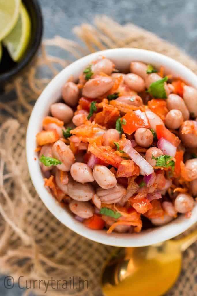 spicy raw peanut salad with carrots and onion in small bowl