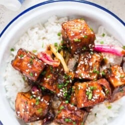 general tso's tofu served with rice in white plate