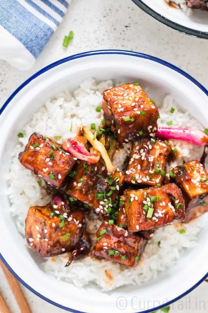 general tso's tofu served with rice in white plate