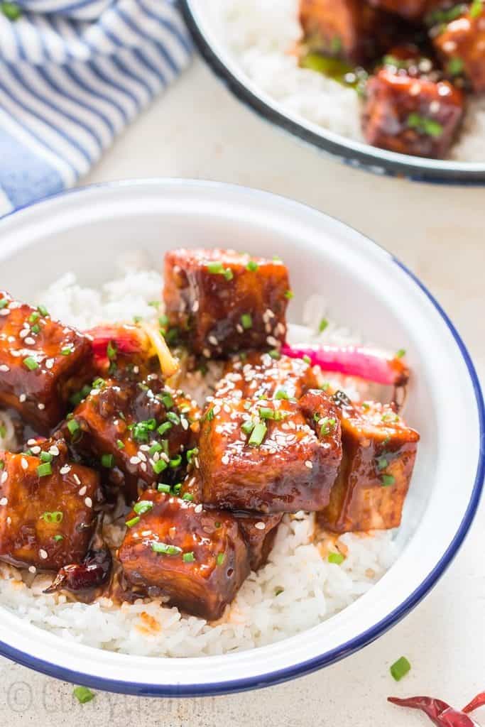 general tso's tofu served with rice in white plate