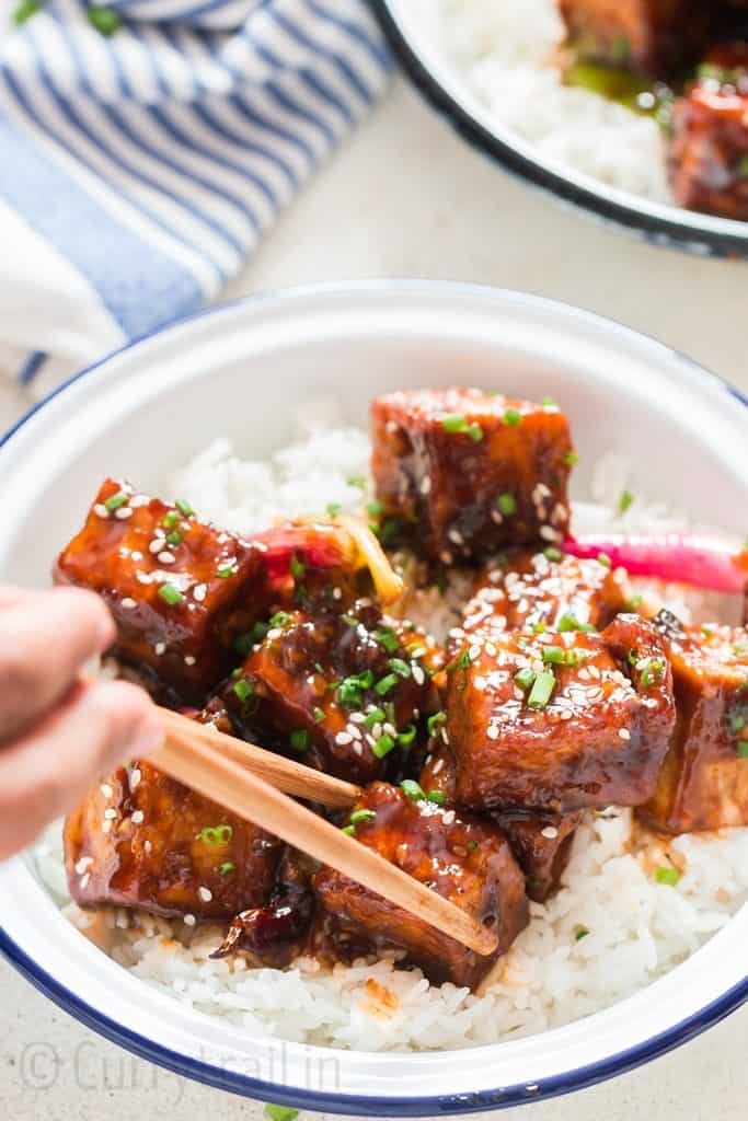 general tso's tofu served with rice in white plate