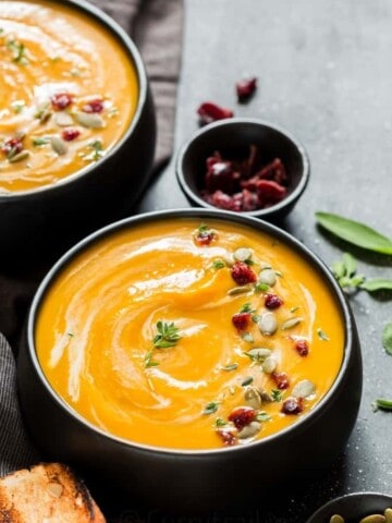 instant pot butternut squash soup served in 2 black bowl