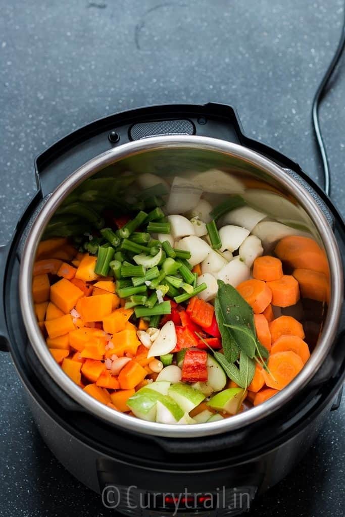 instant pot butternut squash soup ingredients inside the pot ready to be cooked