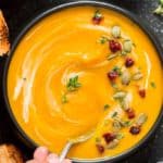 instant pot butternut squash soup served in black bowl with spoon