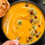 instant pot butternut squash soup served in black bowl with spoon