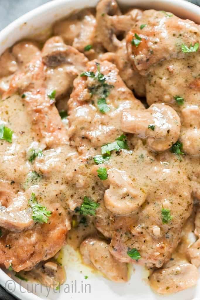 close up view of instant pot chicken marsala garnished with parsley