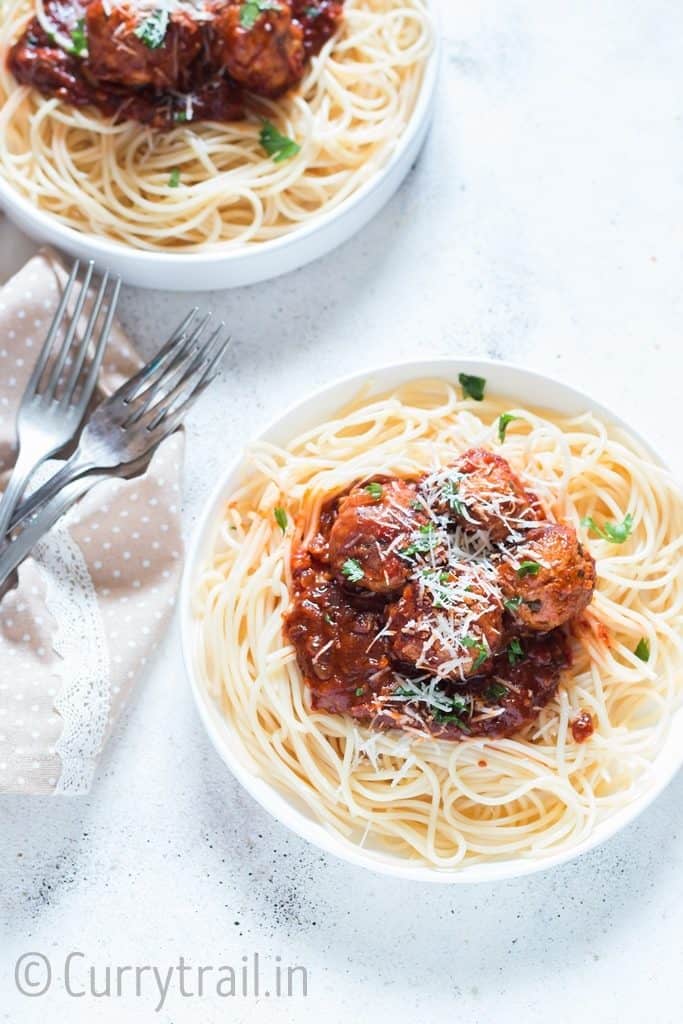 instant pot chicken Parmesan meatballs served on spaghetti in 2 white plates