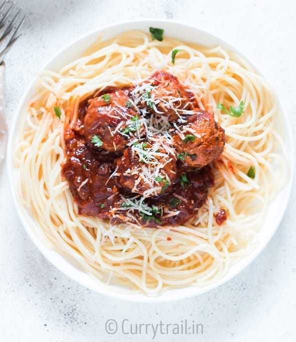 instant pot chicken Parmesan meatballs served on spaghetti in 2 white plates