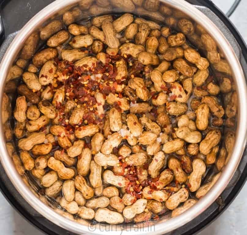 instant pot boiled peanuts with salt and red chili flakes ready to be cooked 