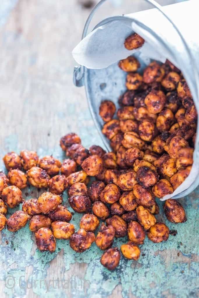 spicy chickpeas roasted in an oven on a wooden board.