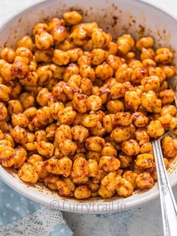 spice mix tossed on chickpea in white bowl