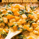 Thai butternut squash curry in skillet with wooden spatula with text