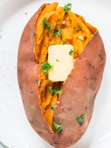 steamed and mashed sweet potatoes served with butter cube and sprinkle with cilantro