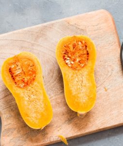 Butternut squash cut into half for making stuffed butternut squash