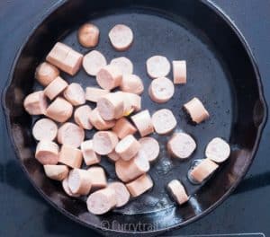 Sausages cooked in cast iron pan