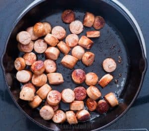 Sausages cooked in cast iron pan
